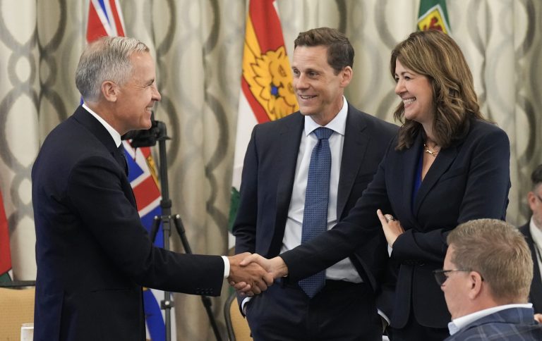 Canadian Prime Minister Mark Carney, left, greets Alberta Premier Danielle Smith, right, and Prince Edward Island Premier Rob Lantz during the meeting of Canada's premiers in Huntsville, Ont., on Tuesday, July 22, 2025. THE CANADIAN PRESS/Nathan Denette